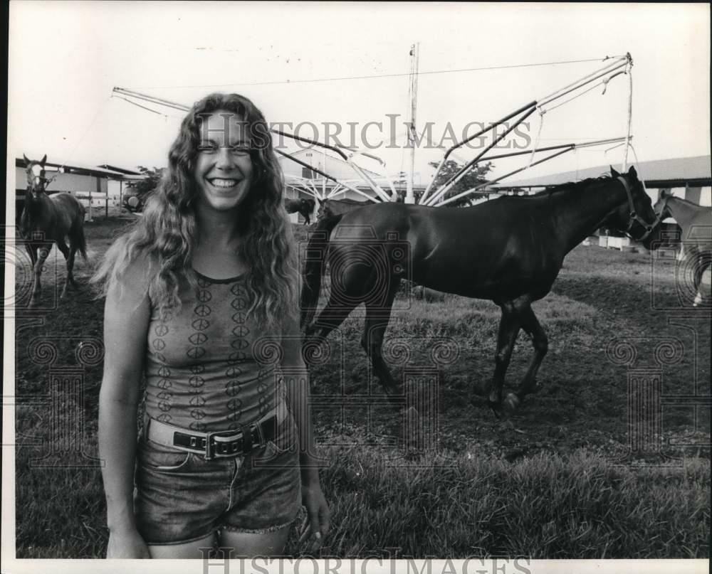 Press Photo Poster painting Jockey smiles happily with her horses behind - sax25515