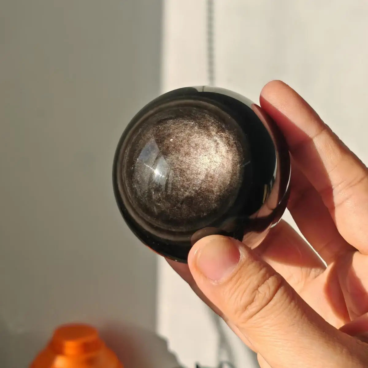 Silver sheen obsidian sphere close-up