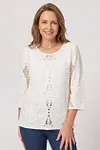 Front view of elegant white eyelet embroidered blouse with 3/4 sleeves and lace panels
