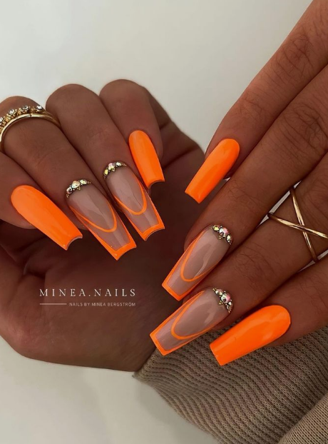 Experience the explosion of neon orange nails