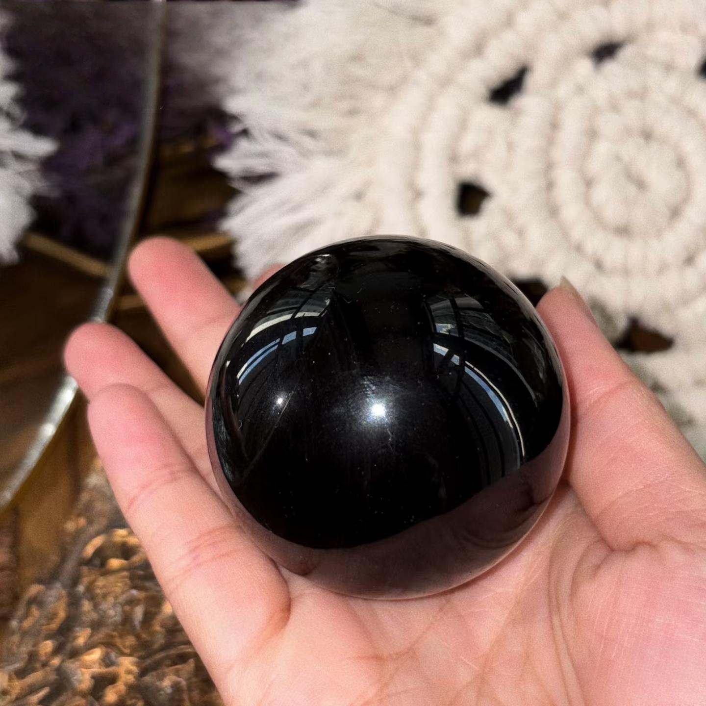 Black obsidian sphere natural surface detail