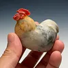 A plump, round rooster hand-carved from natural Shoushan stone, showcasing the natural colors and textures of the stone