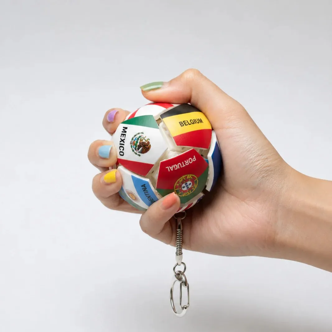 Hand holding football fidget keychain Hand holding football fidget keychain