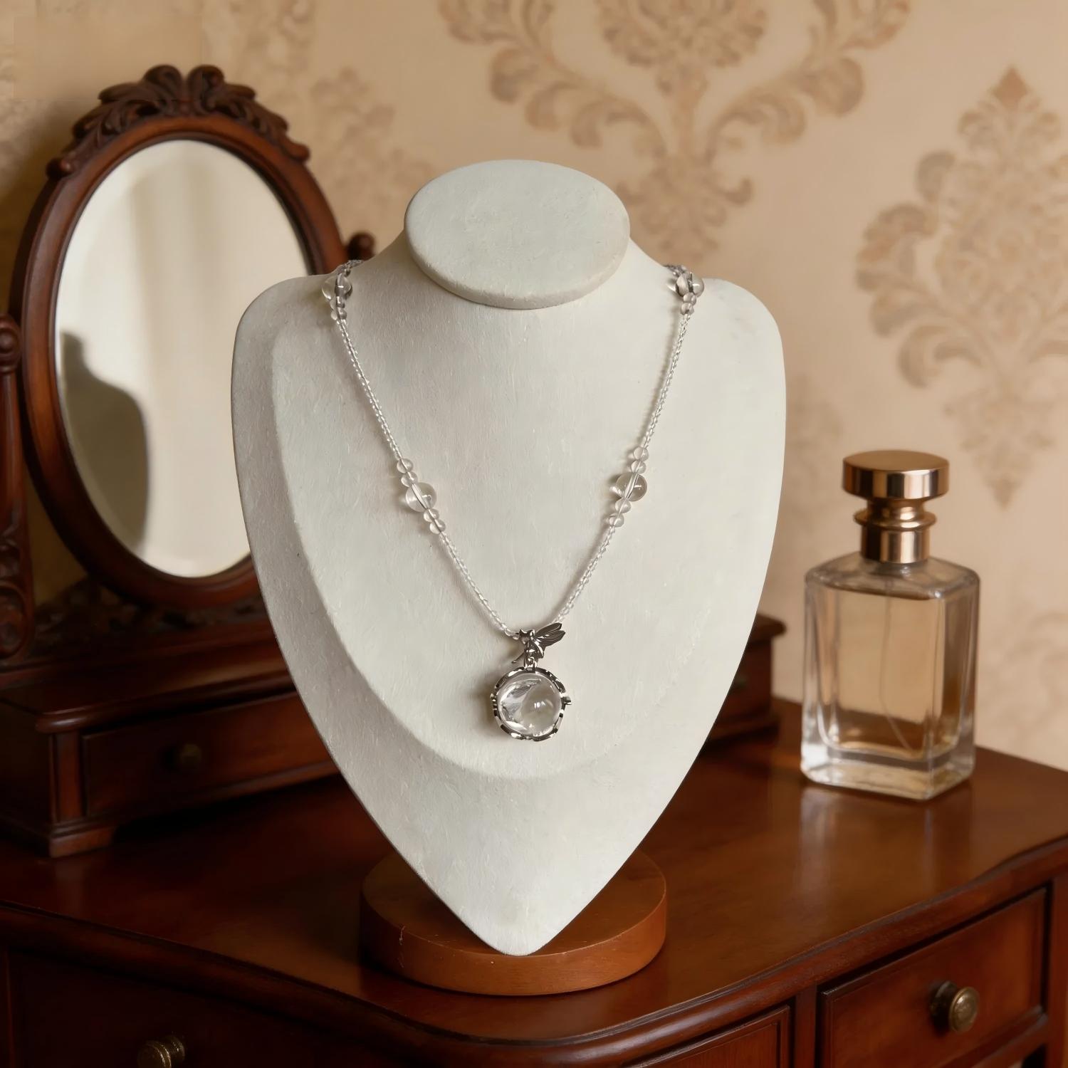 Clear Quartz Necklace White Crystal Pendant & Beaded Chain on the table