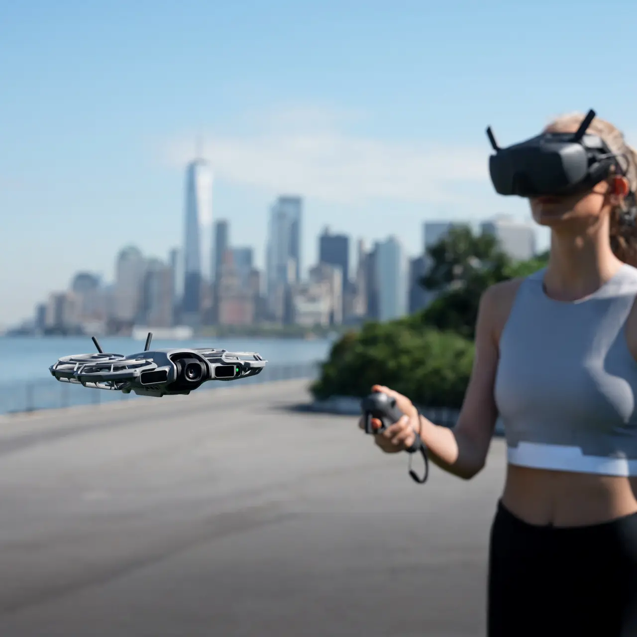 A woman is wearing a DJI Goggles N3 and operating a DJI Neo 2.