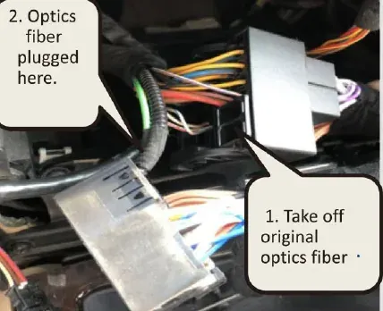 BMW fibre-optic insert being moved into the Android screen harness plug