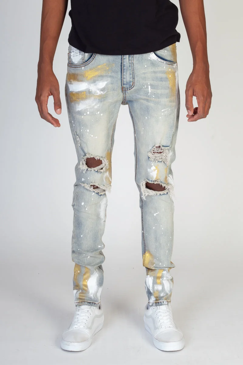 RIPPED JEANS WITH GOLD PAINT BRUSH