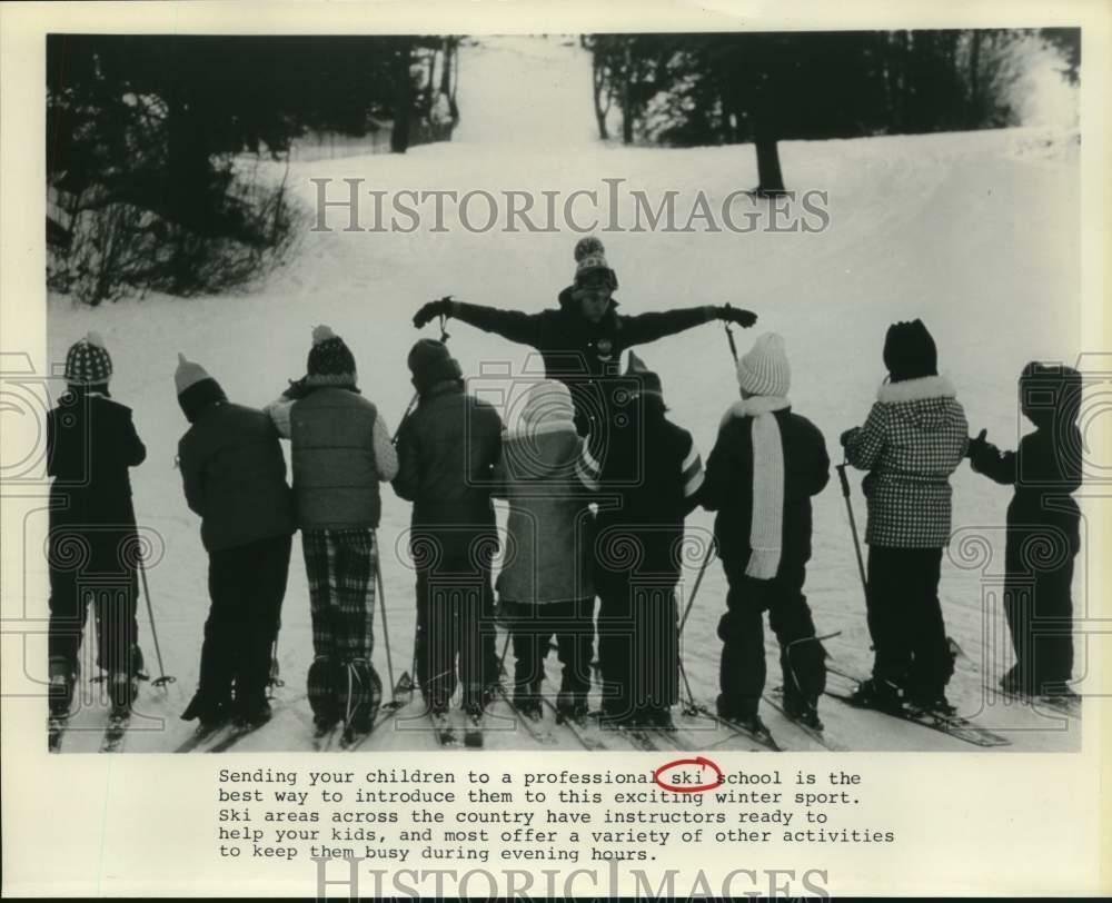 Press Photo Poster painting Children listen to trainer at professional ski school - sax26815