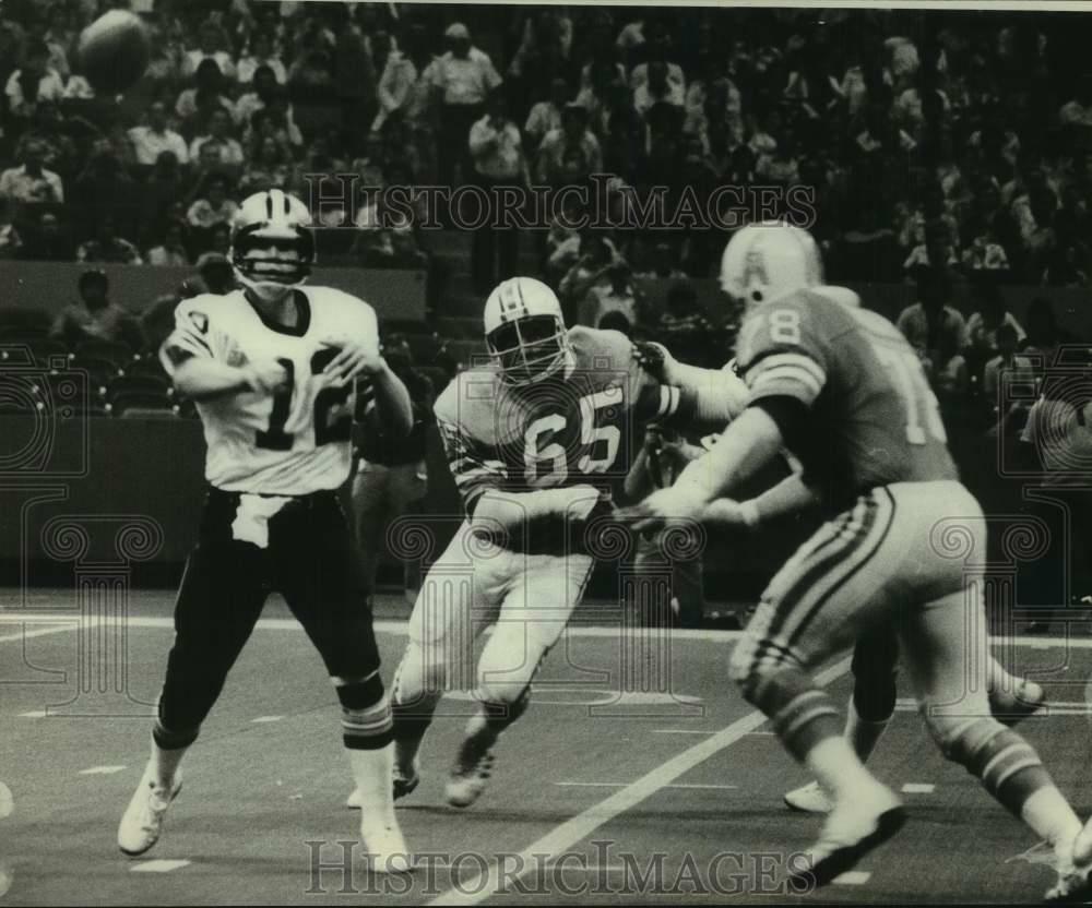 Press Photo Poster painting New Orleans football quarterback Bobby Scott throws pass in a game