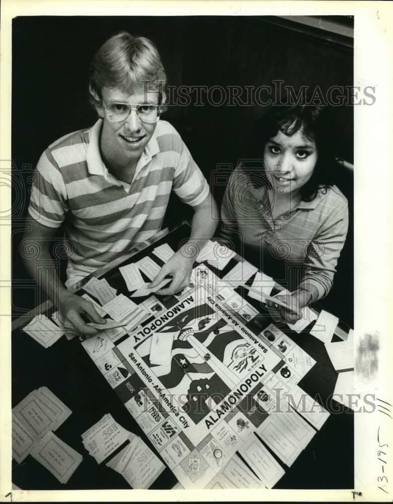 Press Photo Poster painting Scott Colleen and Diana Arguello play Alamonopoly Game - sax30470