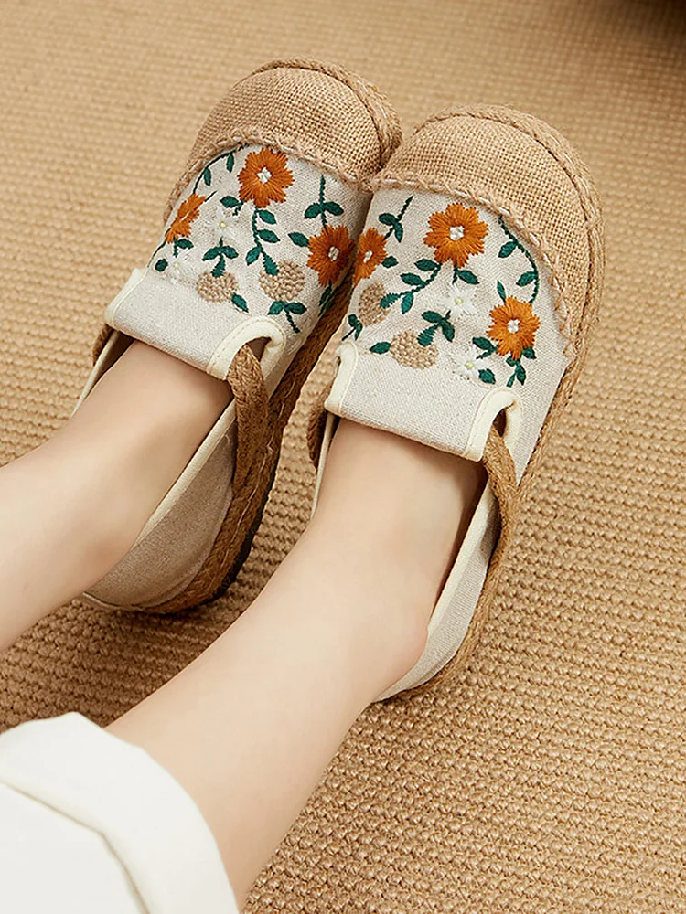 Women's straw shoes with summery floral embroidery.