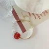 Bracelet de perles avec n&oelig;ud rose rouge