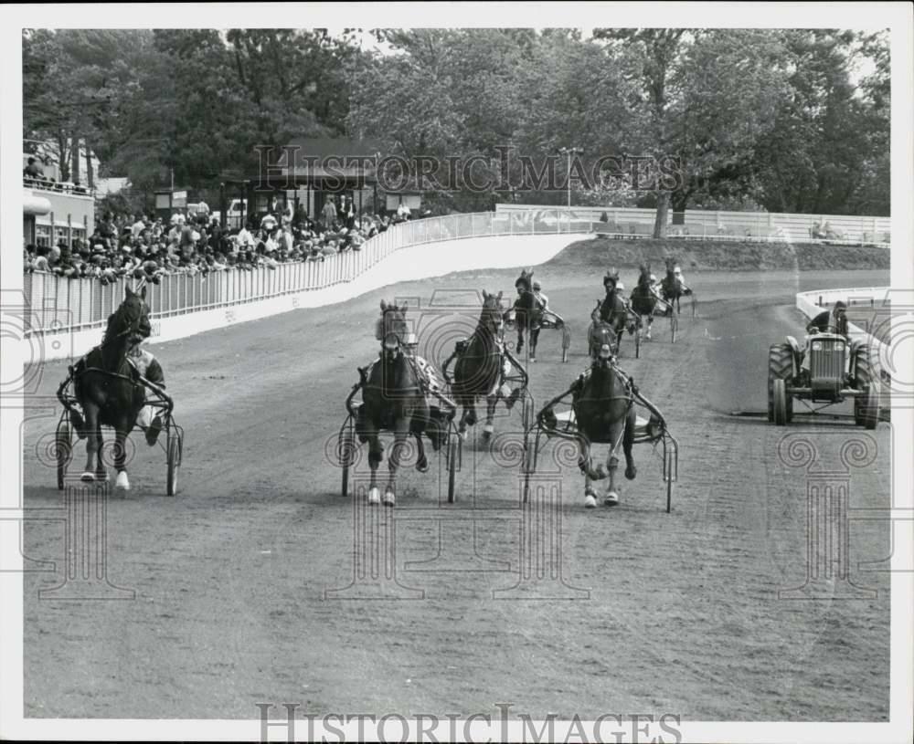 Press Photo Poster painting Horses in action during harness racing at hold Raceway track