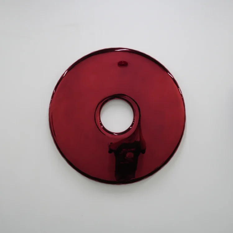 Red mirrored stainless steel round wall hanging &ndash; donut-shaped interior art piece
