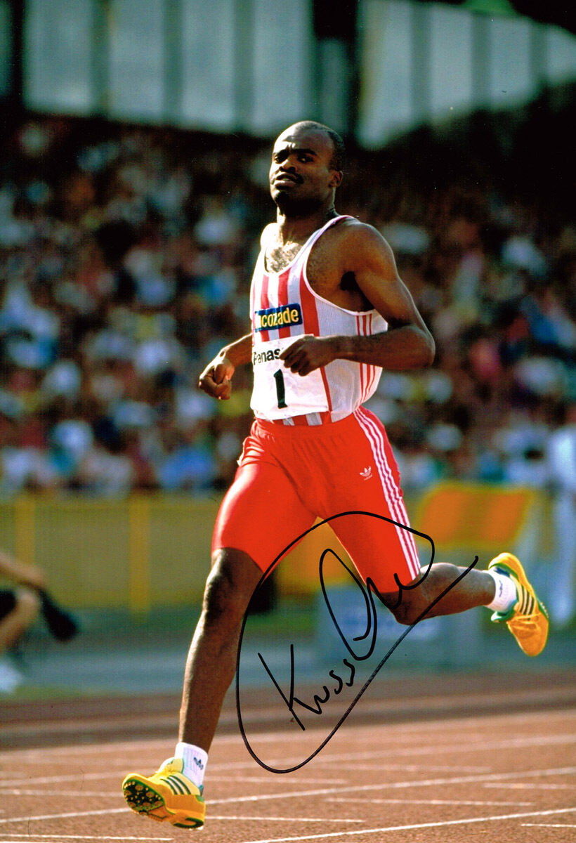 Kriss Akabusi GENUINE HAND SIGNED Autograph 12x8 Photo Poster painting AFTAL COA British Athlete