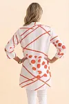 Back view of women's white and olive geometric print tunic showing longline length and relaxed fit