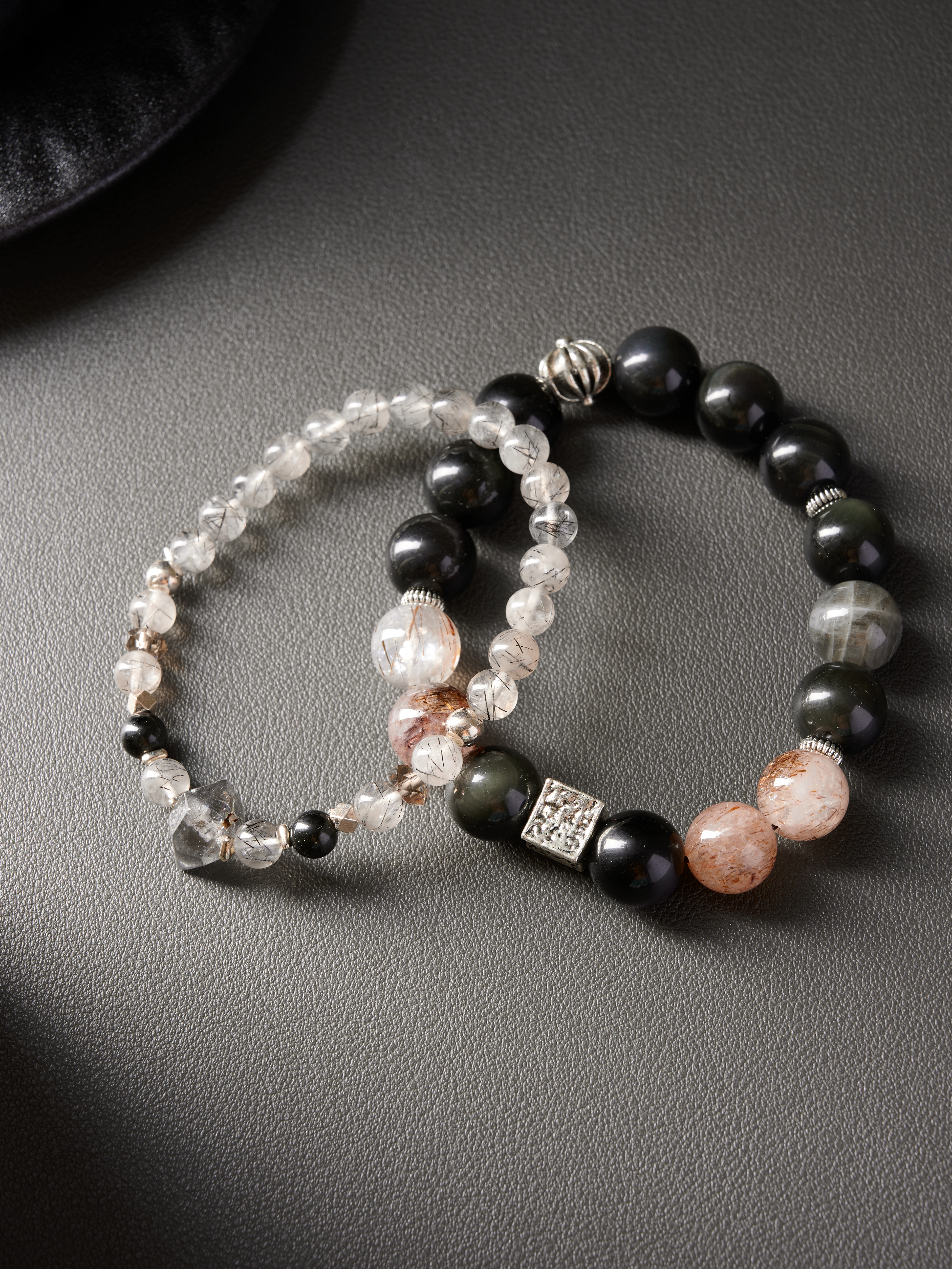 AvigJewelry couple bracelets — rutilated quartz, obsidian, smoky & clear quartz, flat lay, 16–18 cm elastic
