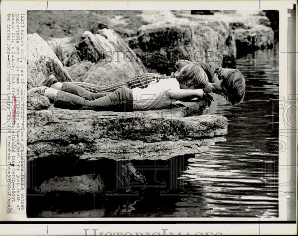 Press Photo Poster painting Boys lay on rock to check fish at Loose Park Lake in Kansas City