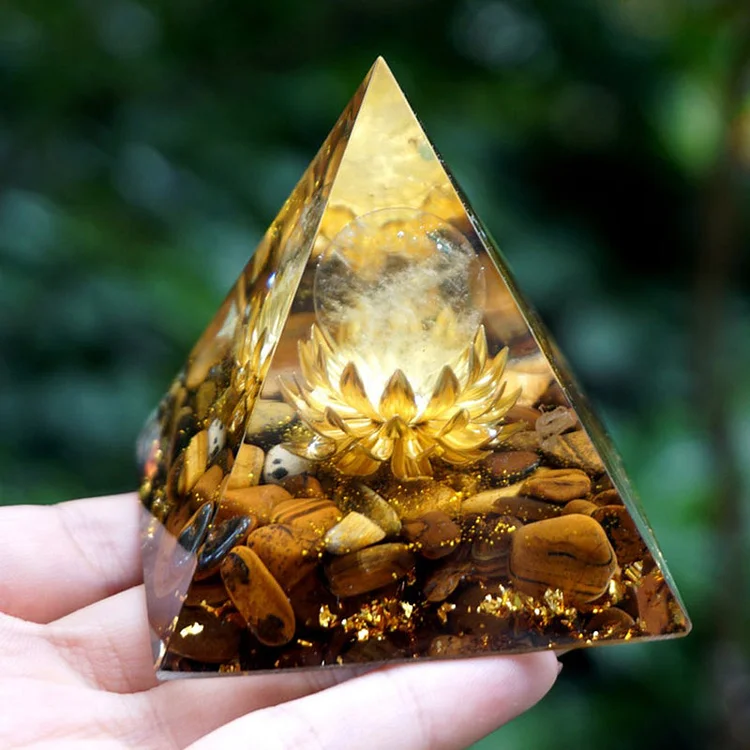 clear crystal and tiger eye orgone pyramid with lotus symbol
