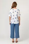 Back view of polka dot linen top and blue wide-leg trousers showing relaxed silhouette and fit