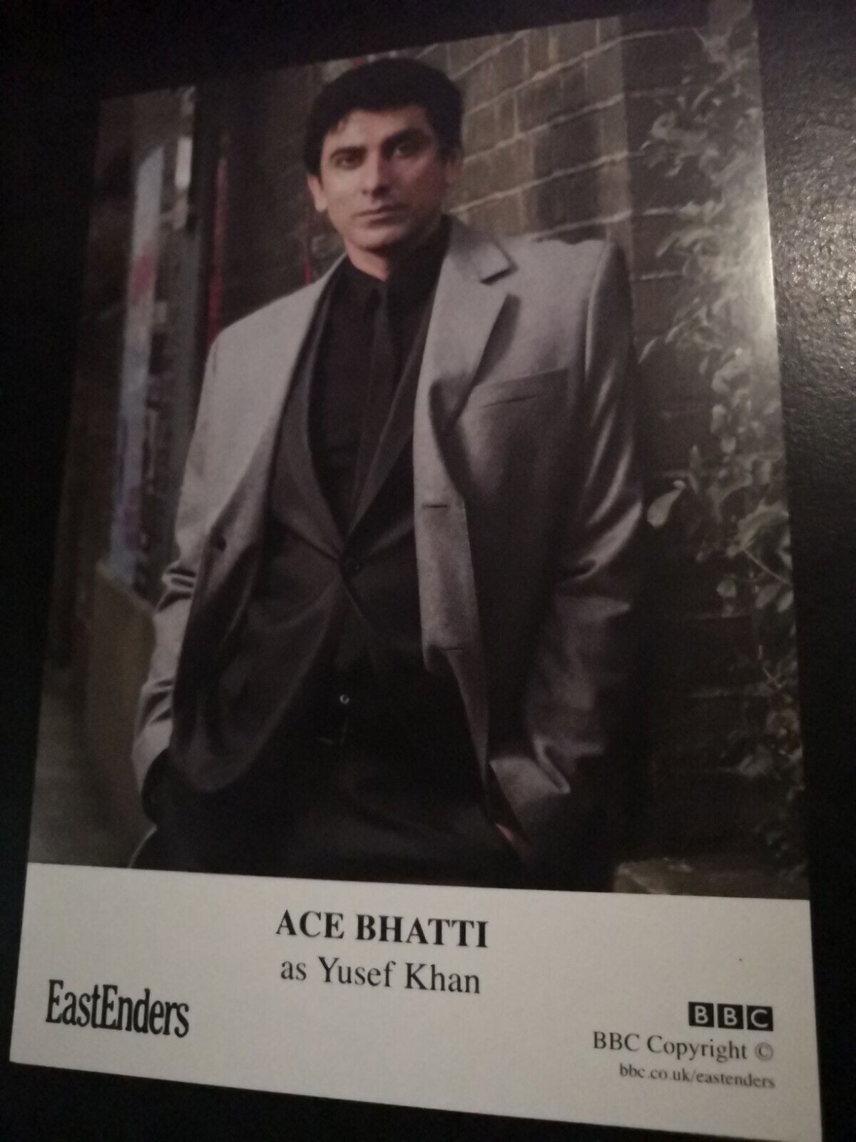 EASTENDERS UNSIGNED CAST CARD OF ACE BHATTI