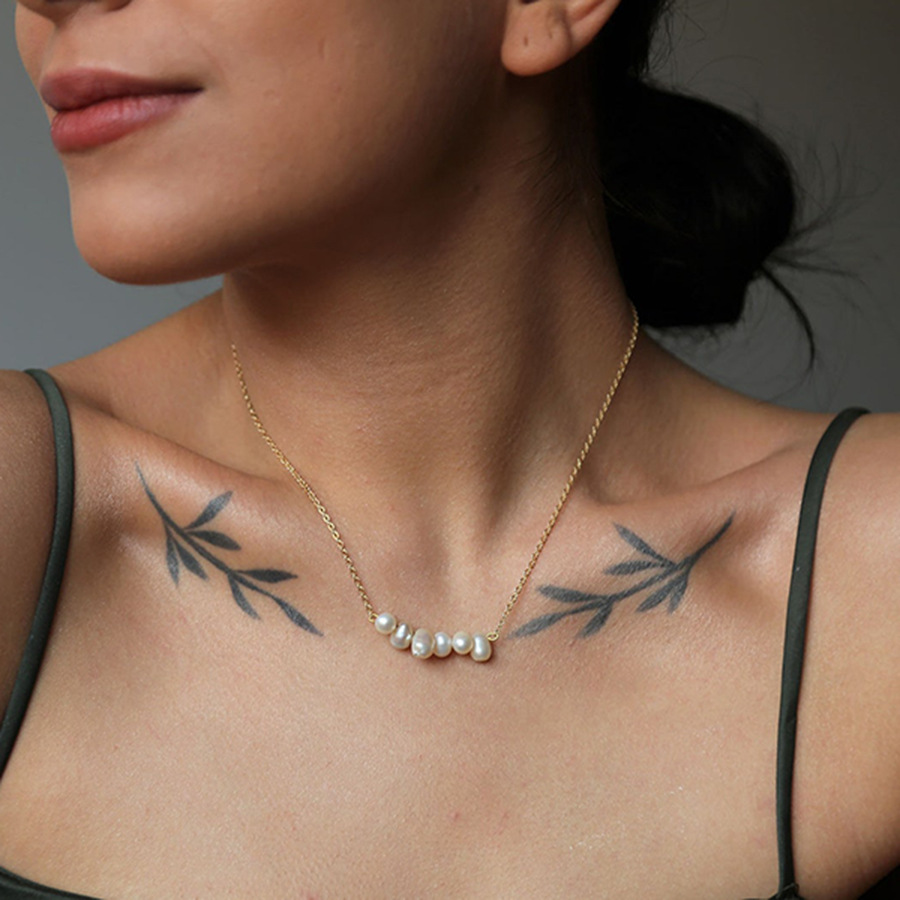 Close-up of natural freshwater pearl necklace with six irregular pearls. 
