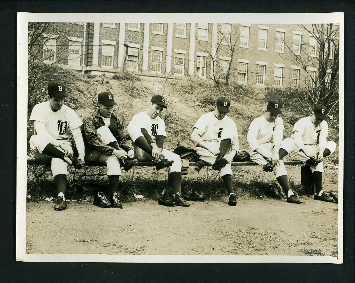 Boston Braves players lace up their spikes circa 1940 's Press Original Photo Poster painting