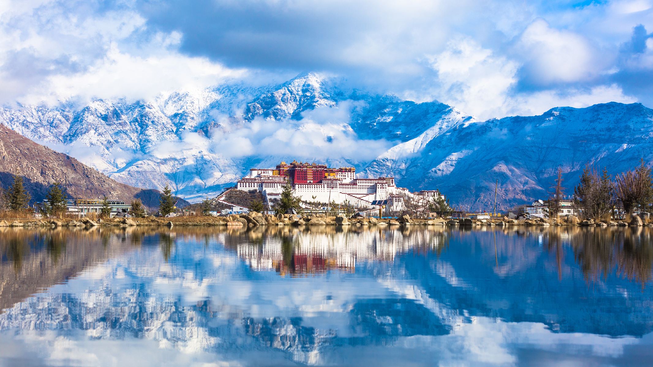 Potala Palace in Tibet surrounded by snow-capped mountains