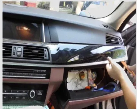 BMW F10 centre air-vent panel being released with a plastic trim tool
