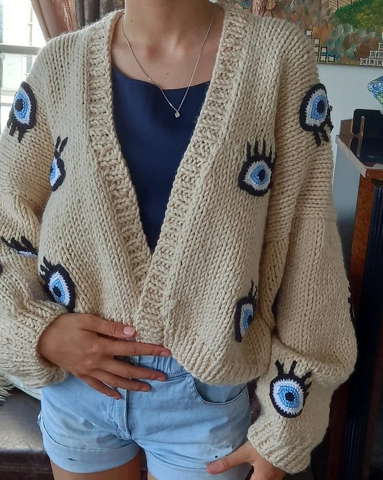 Big eyes adorn cardigan sweater