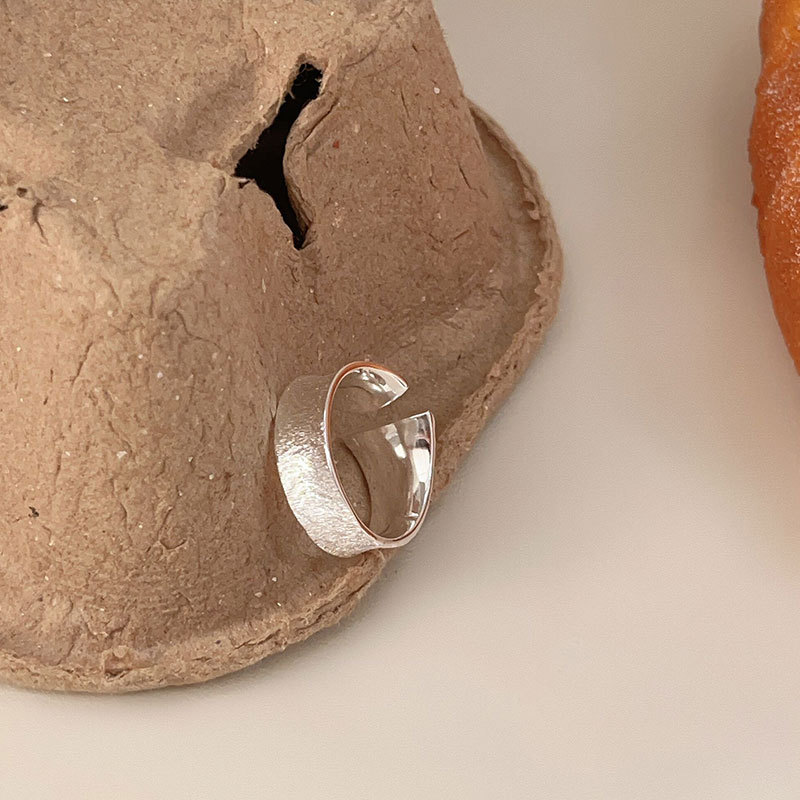 Original design silver rings in soft, elegant lighting.      
